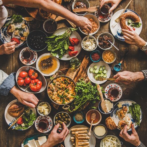 Flat lay of Turkish family eating traditional Middle Eastern breakfast